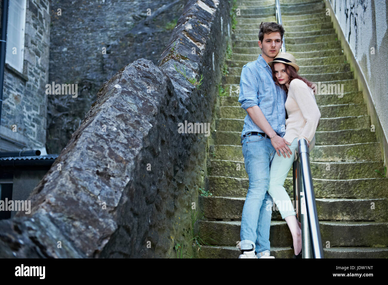 Couple standing on urban steps Stock Photo