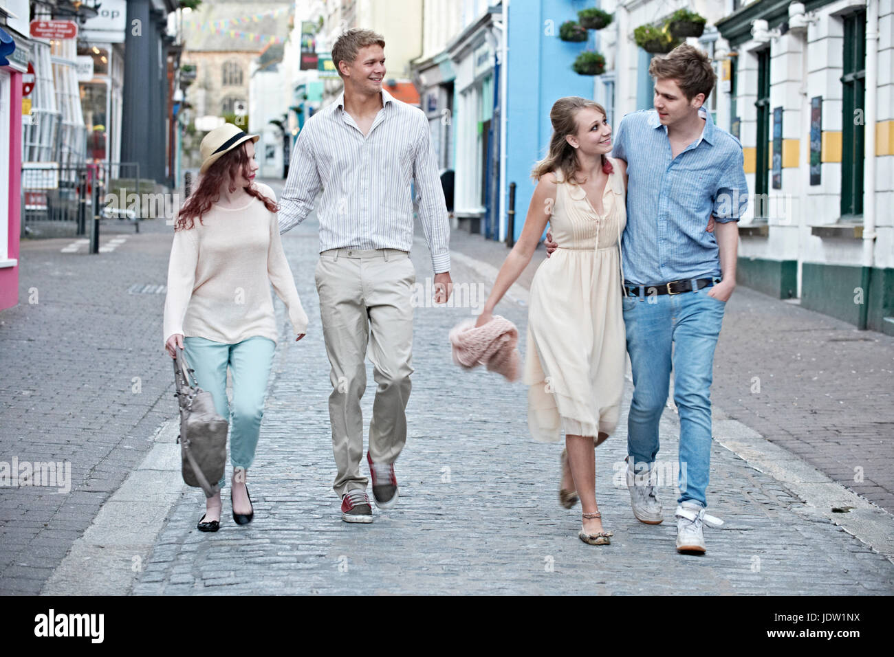 Couples walking together on city street Stock Photo