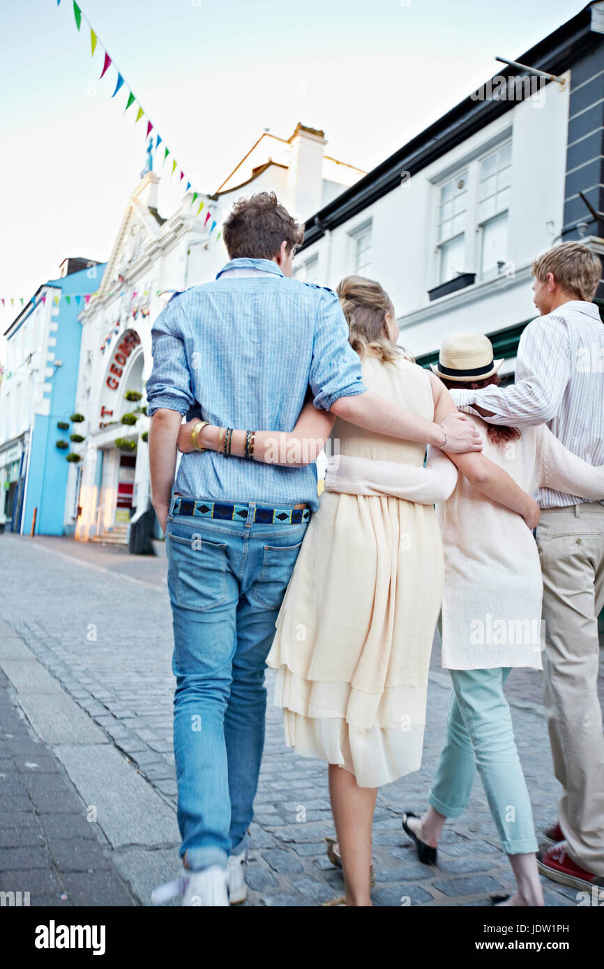 Couples walking together on city street Stock Photo