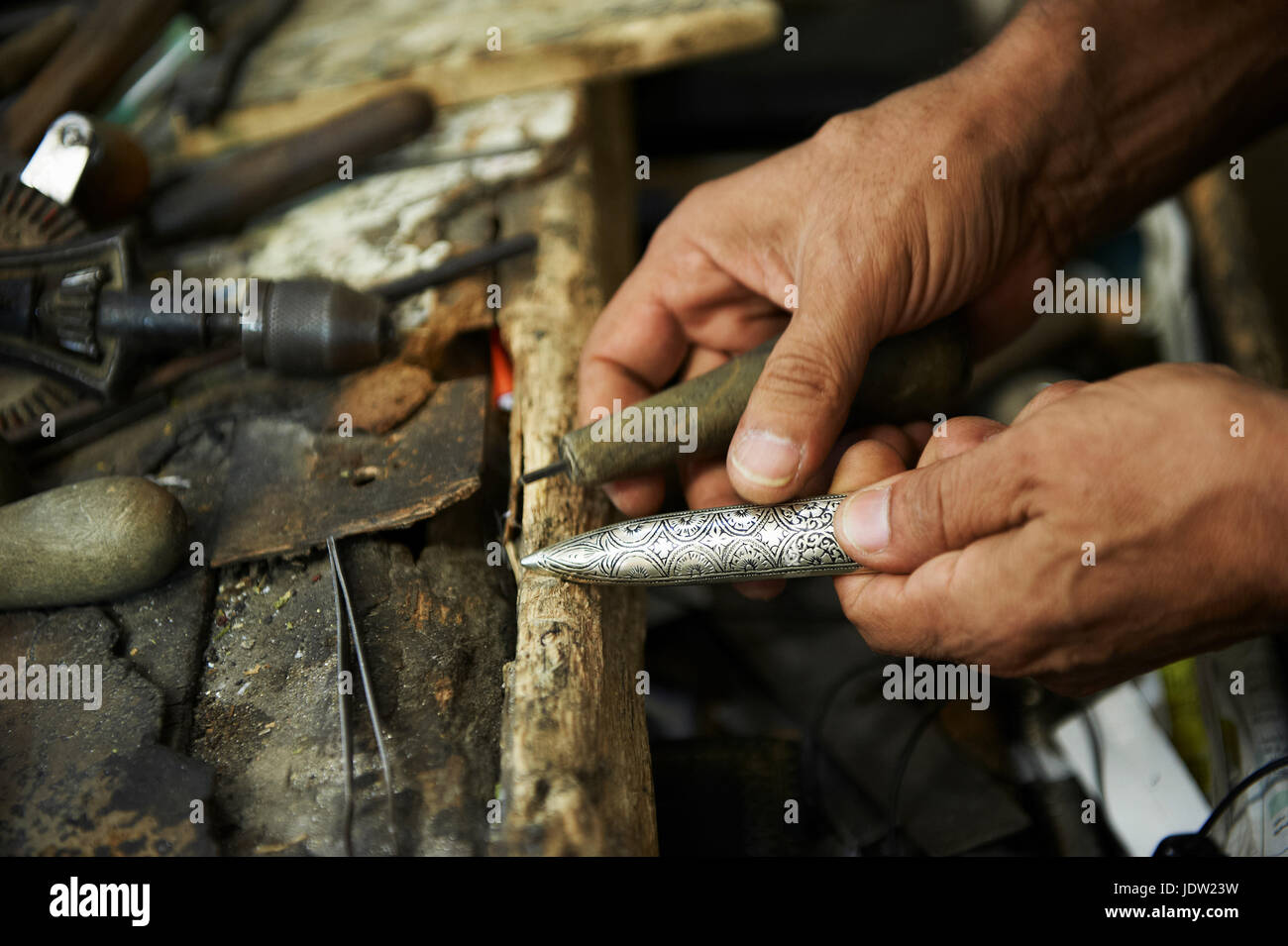 Close up of artisan carving metal Stock Photo Alamy
