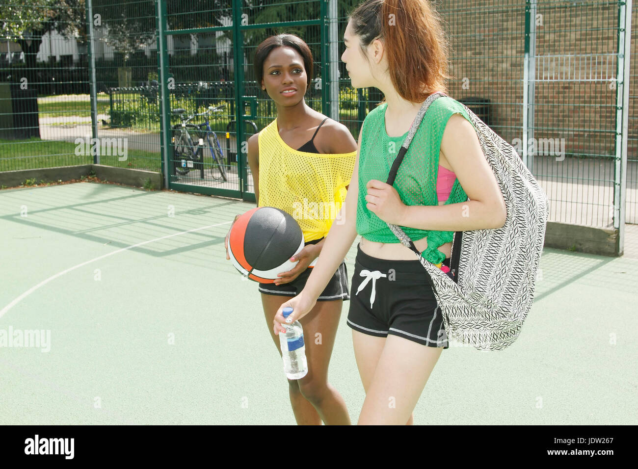 Women walking on basketball court Stock Photo Alamy