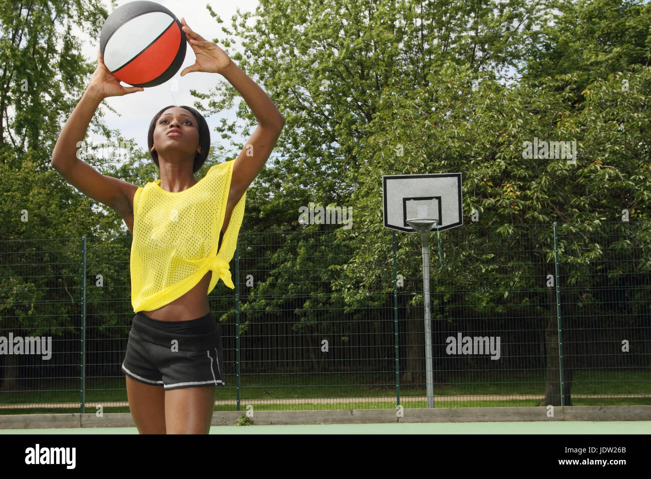 Woman shooting basketball on court Stock Photo Alamy
