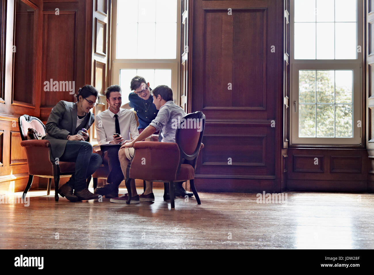 Businessmen talking in ornate room Stock Photo