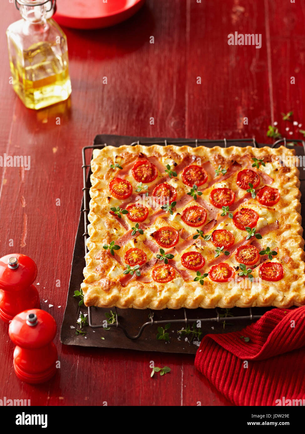 Square pizza with tomatoes and herbs Stock Photo