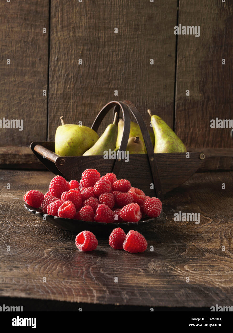 Bowl of raspberries and pears Stock Photo