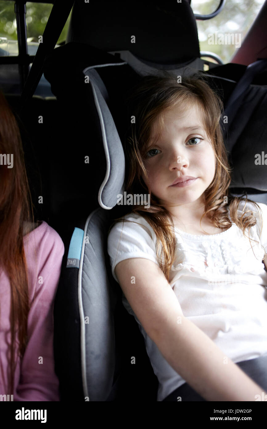 Girl sitting in car seat in backseat Stock Photo Alamy