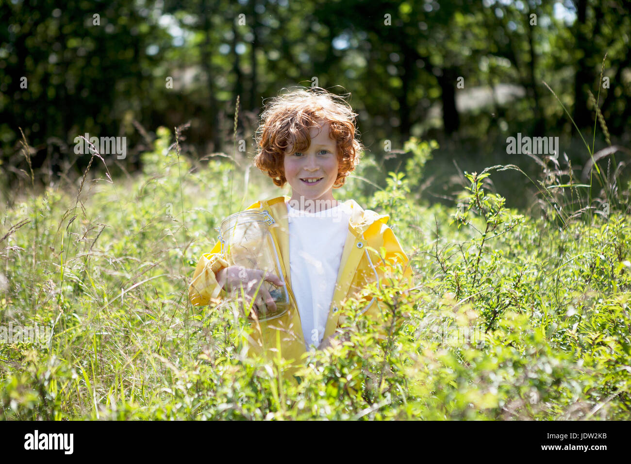 Girl standing in field of tall grass Stock Photo