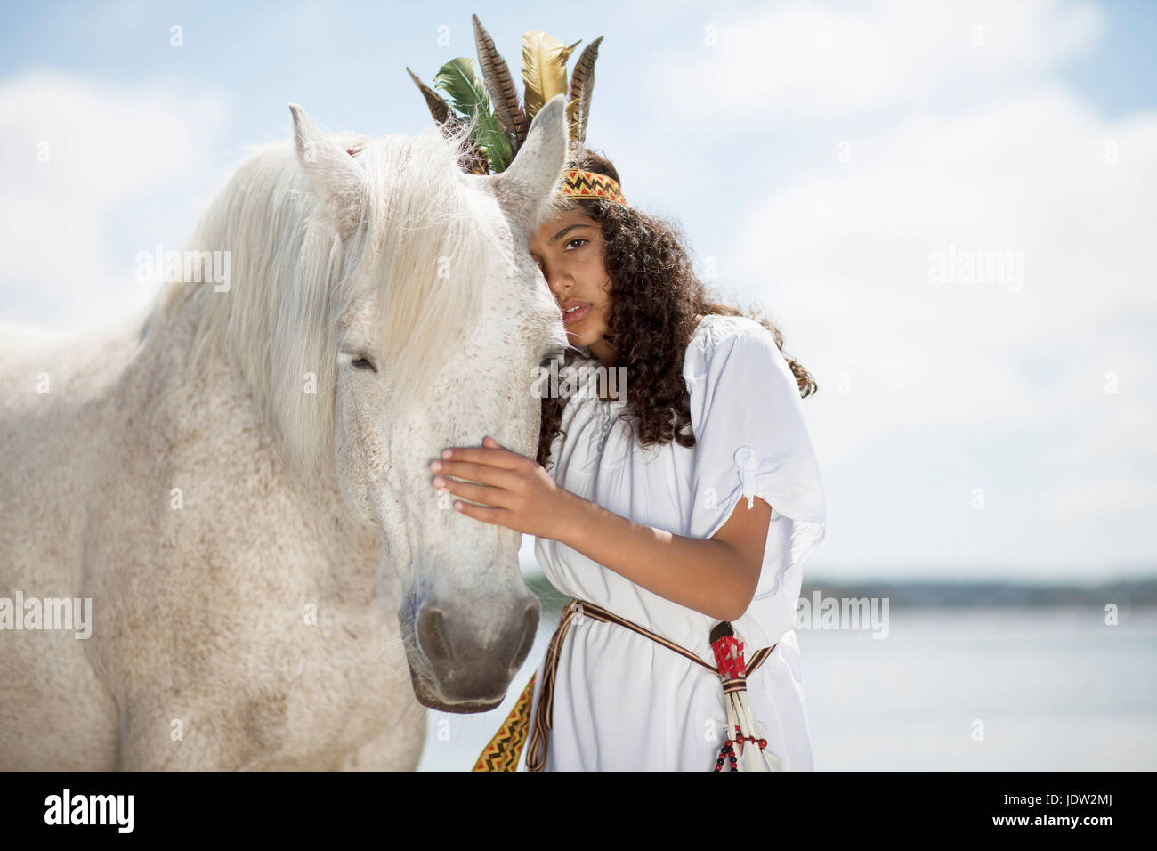 Girl hugging horse outdoors Stock Photo