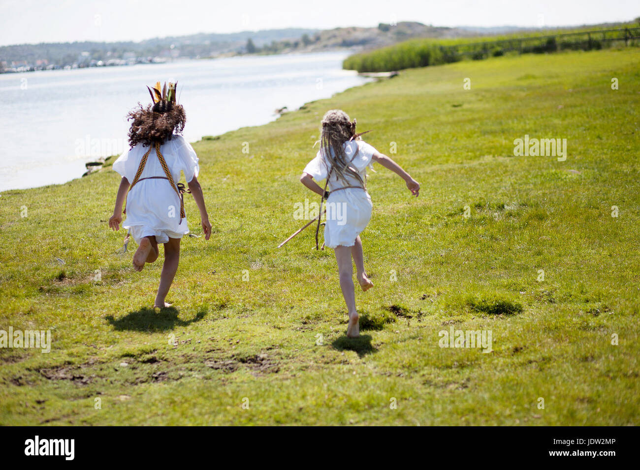 Girls running in Native American costume Stock Photo