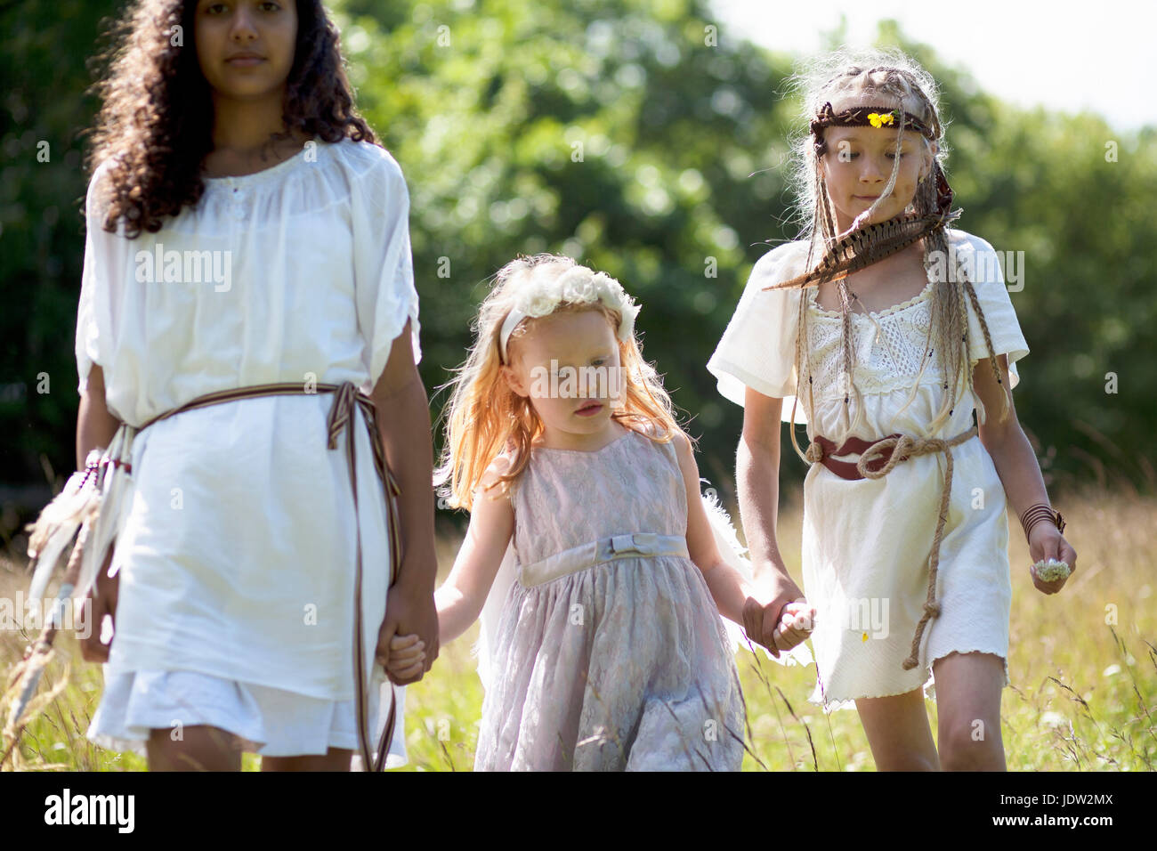 Girls in costumes walking outdoors Stock Photo