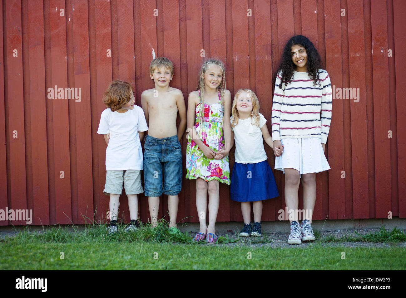 Children standing together outdoors Stock Photo