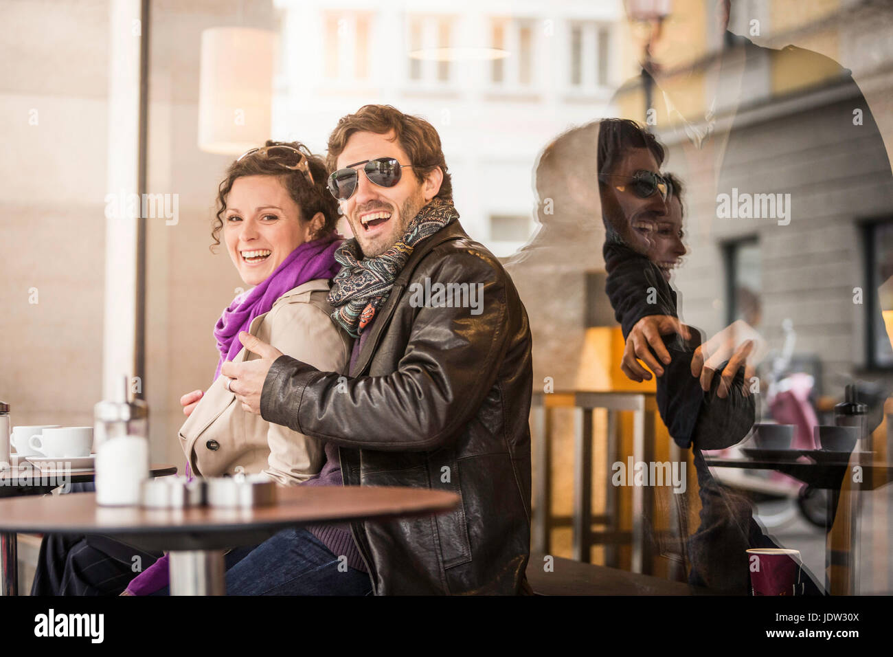 Couple having coffee at sidewalk cafe Stock Photo