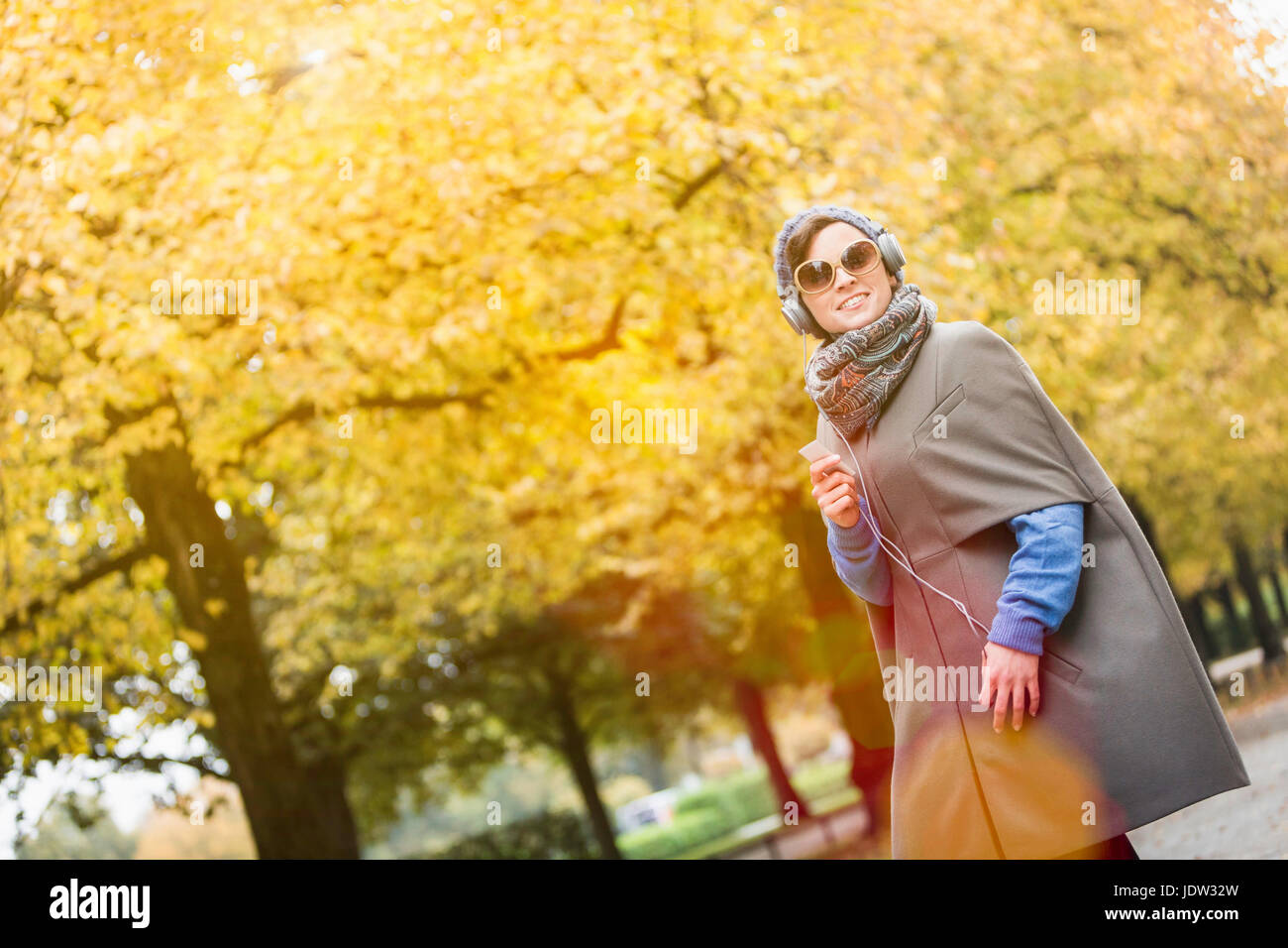 Woman listening to headphones in park Stock Photo