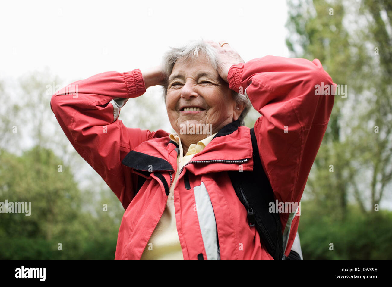 Frustrated older woman walking in park Stock Photo