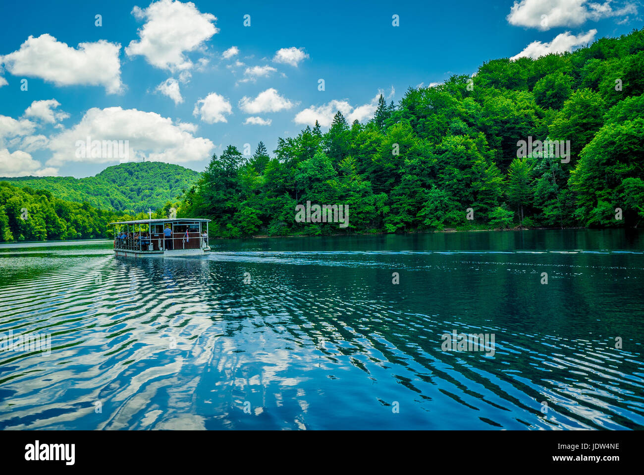 The largest lake at Plitvice Lakes National Park connects the upper and lower lakes. Tourists take a boat to transfer between. Stock Photo