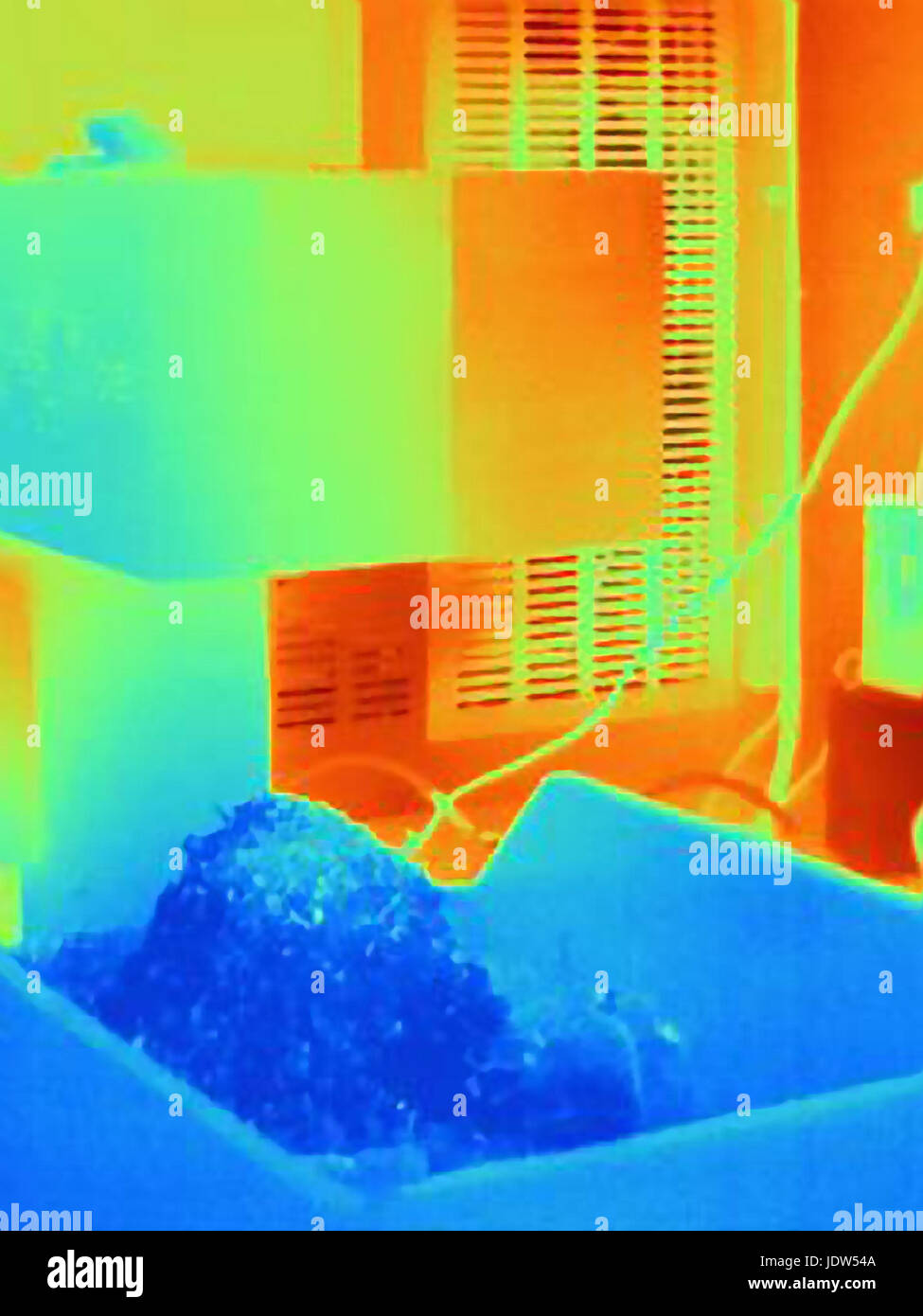 Thermal image of cold metal shavings falling from CNC machine Stock Photo