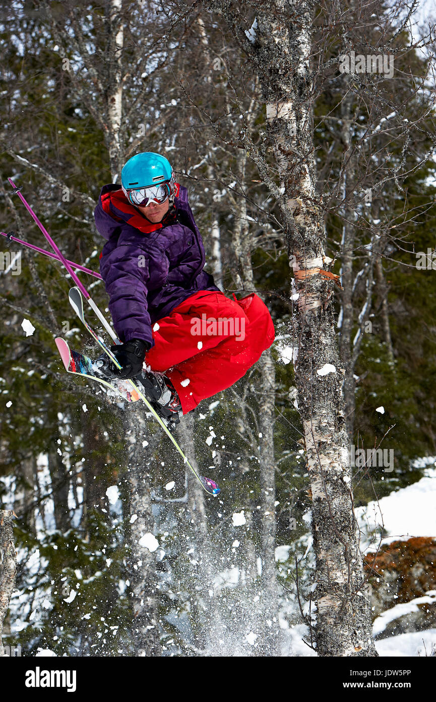 Skier jumping mid air with trees, Are, Sweden Stock Photo