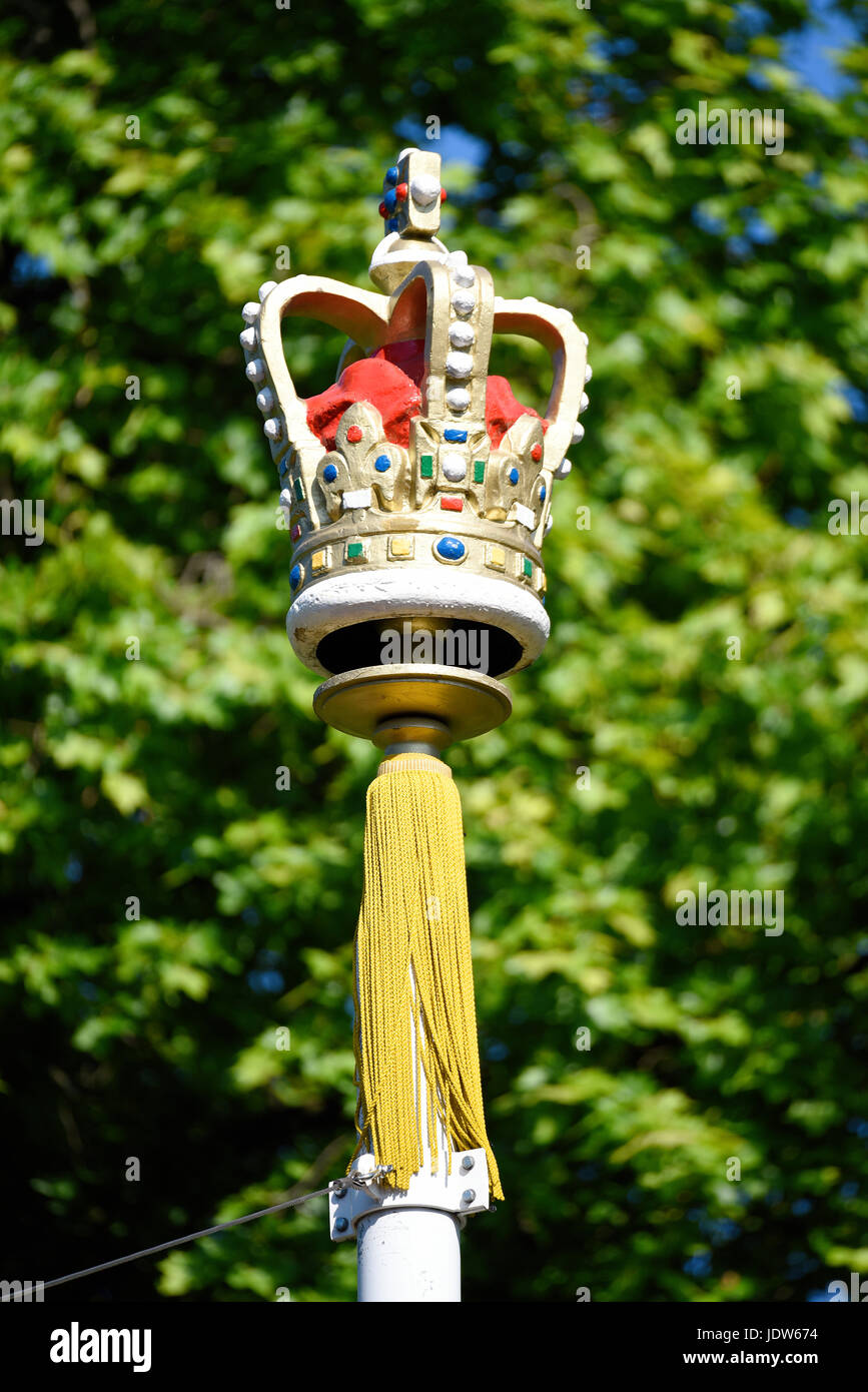 A crown embellishment on top of a flag pole holding a union flag during Trooping the Colour 2017 in The Mall, London. Space for copy Stock Photo