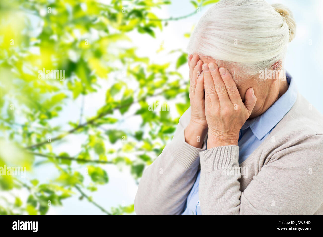 senior woman suffering from headache or grief Stock Photo