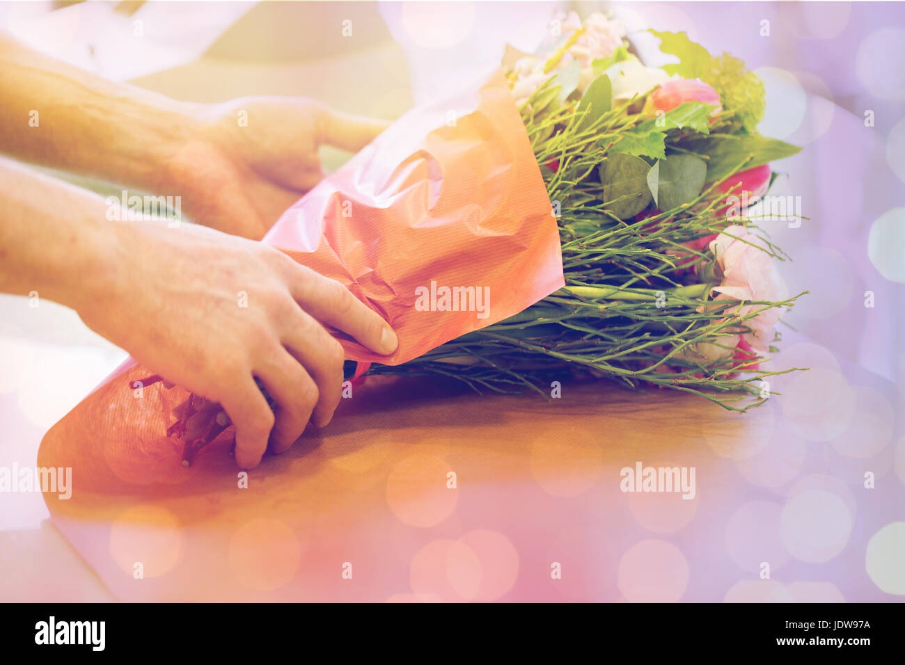 florist wrapping flowers in paper at flower shop Stock Photo Alamy