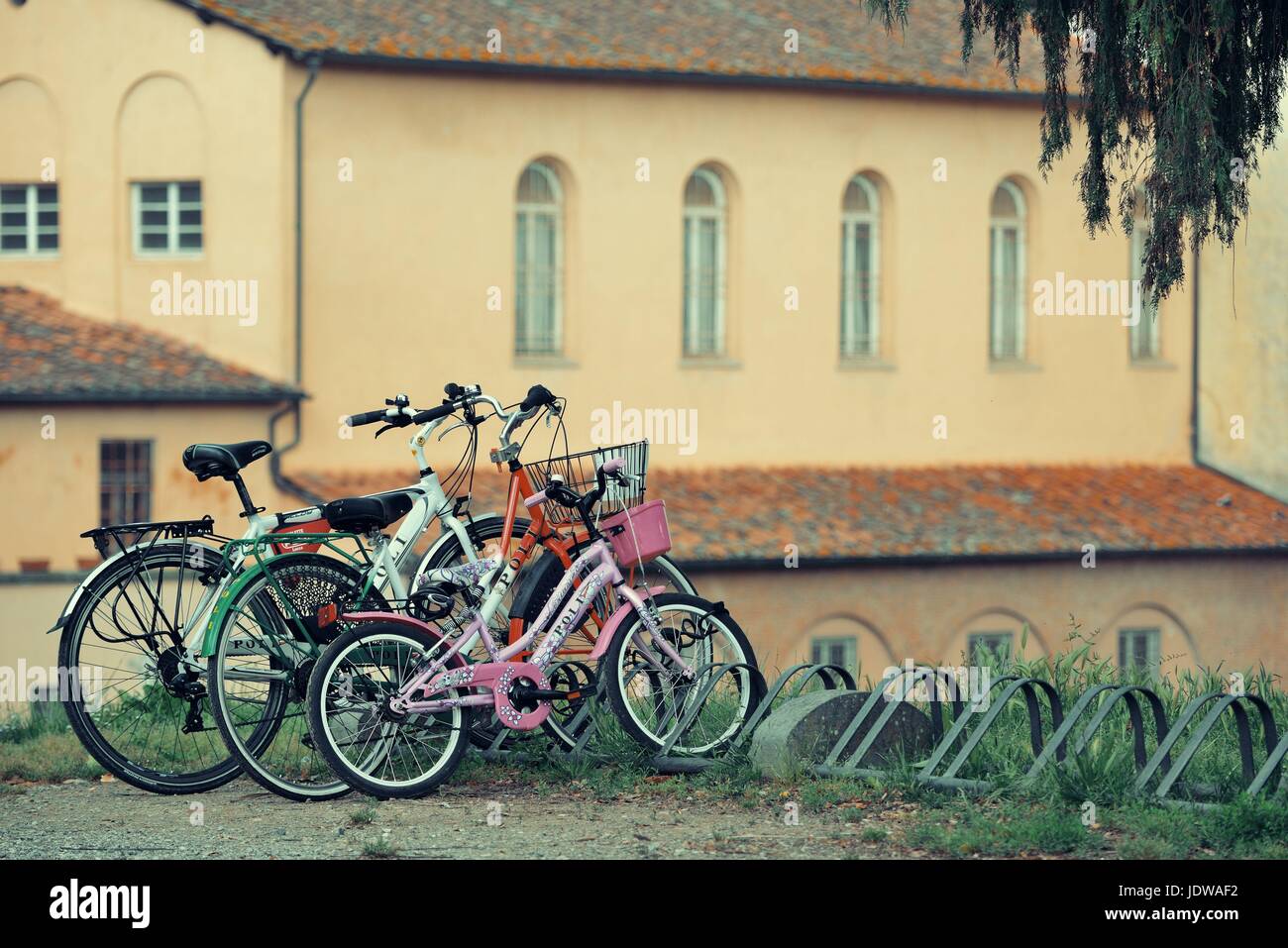 LUCCA - MAY 19: Bikes with old church on May 19, 2016 in Lucca, Italy. It is famous for its well preserved Renaissance-era city walls and the tourism  Stock Photo
