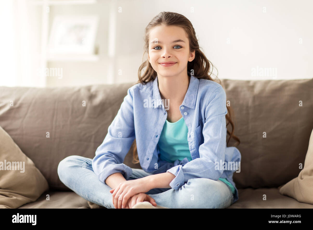 Happy child girl sitting sofa hi-res stock photography and images - Alamy