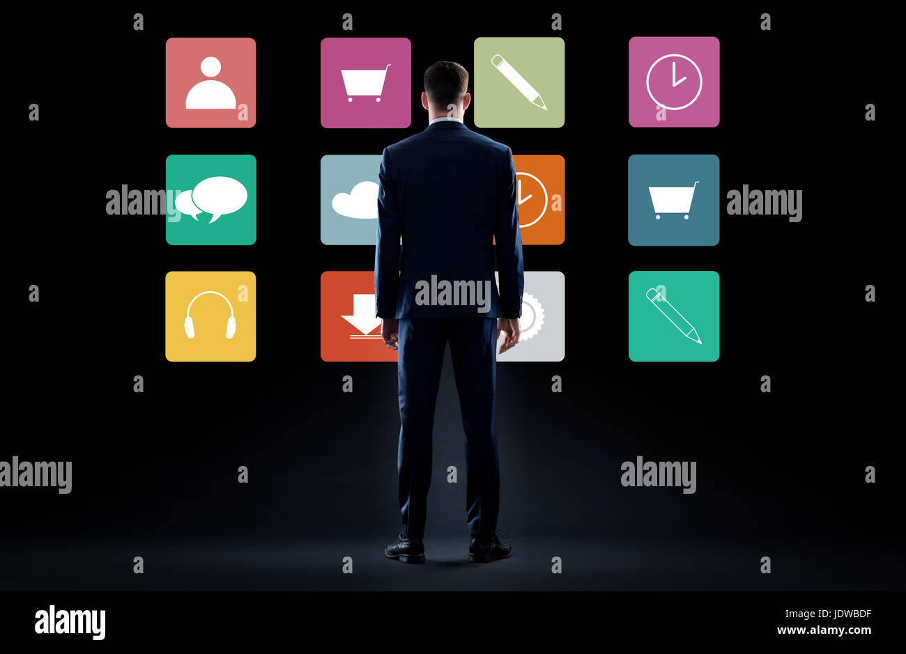 businessman in suit looking at virtual menu icons Stock Photo