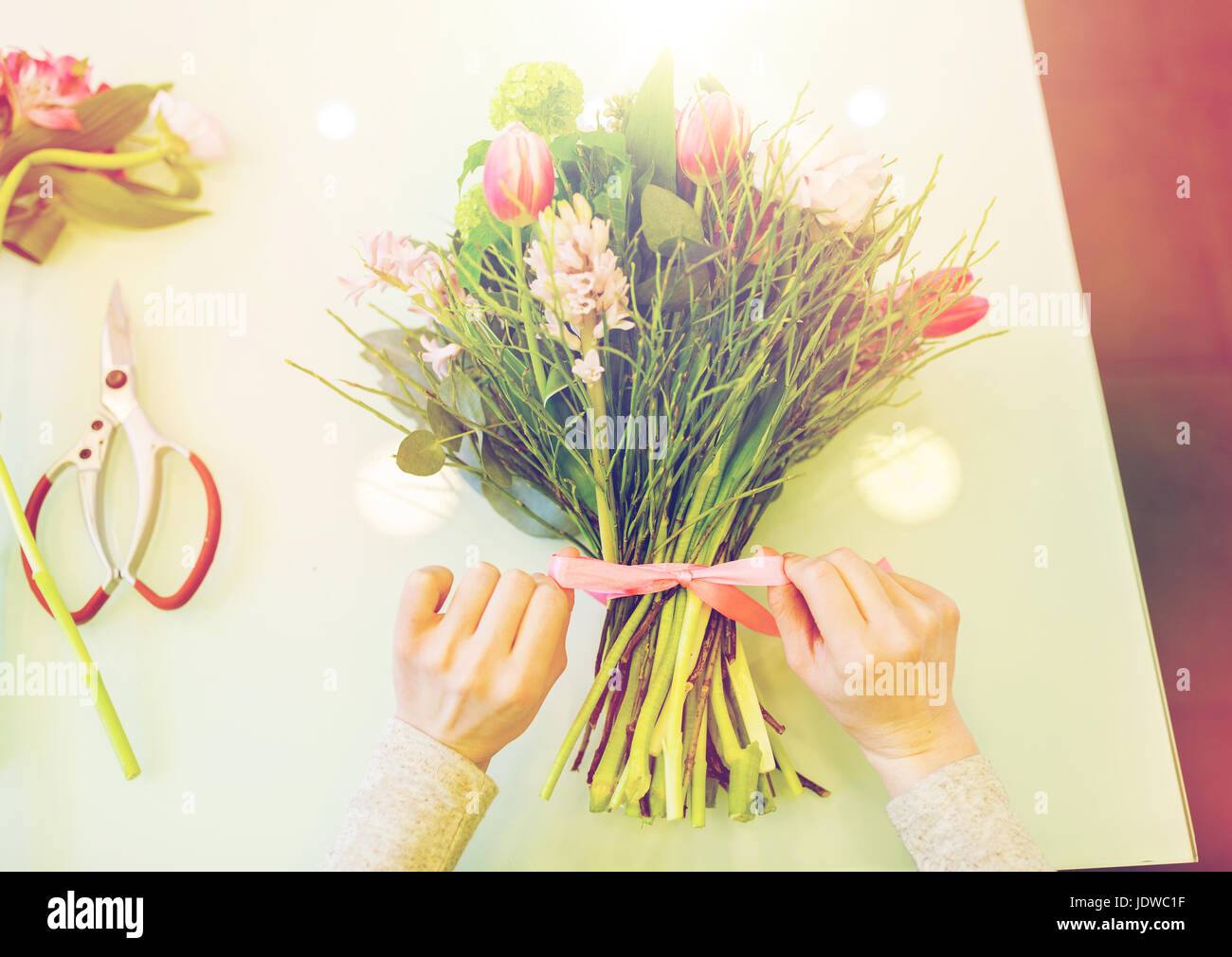 close up of woman making bunch at flower shop Stock Photo - Alamy