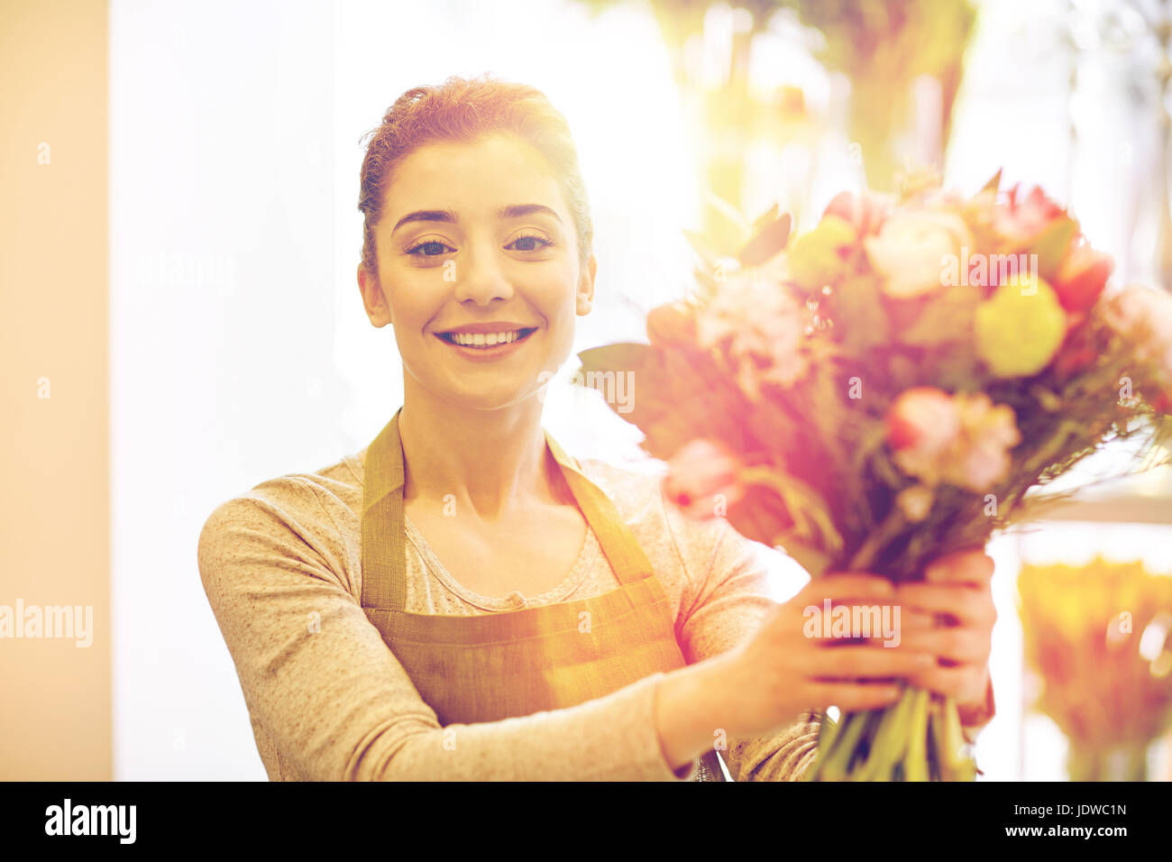 smiling florist woman making bunch at flower shop Stock Photo - Alamy