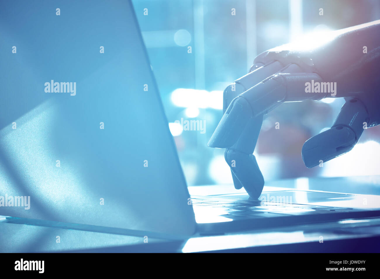 Robot finger point to laptop button with blue tone image. Chat bot , artificial intelligence , robo advisor , robotic concept. Stock Photo