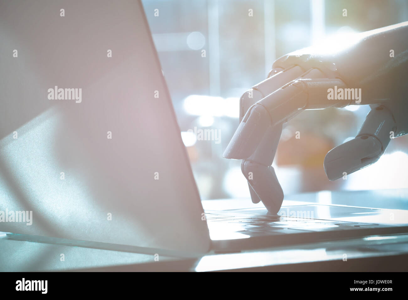Robot finger point to laptop button. Chat bot , artificial intelligence , robo advisor , robotic concept. Stock Photo