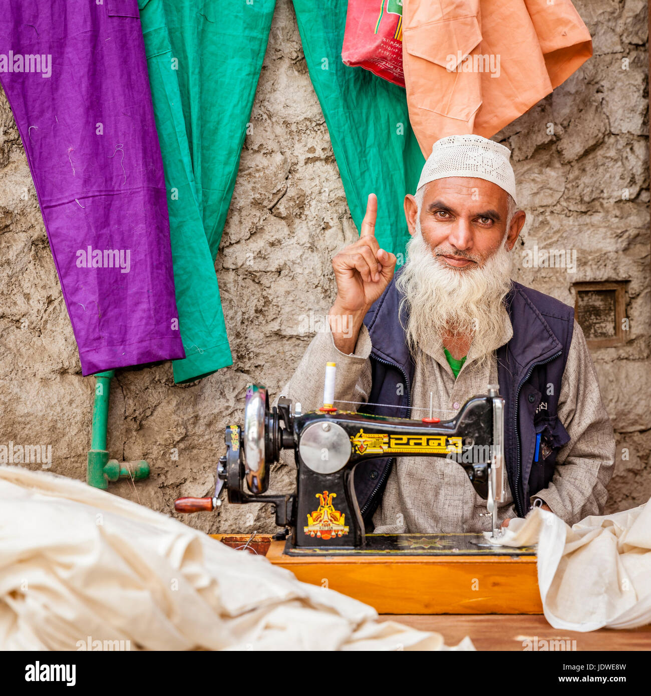 Leh, Ladakh, India, July 12, 2016: a tailor is working at his shop on a small street in Leh, India Stock Photo