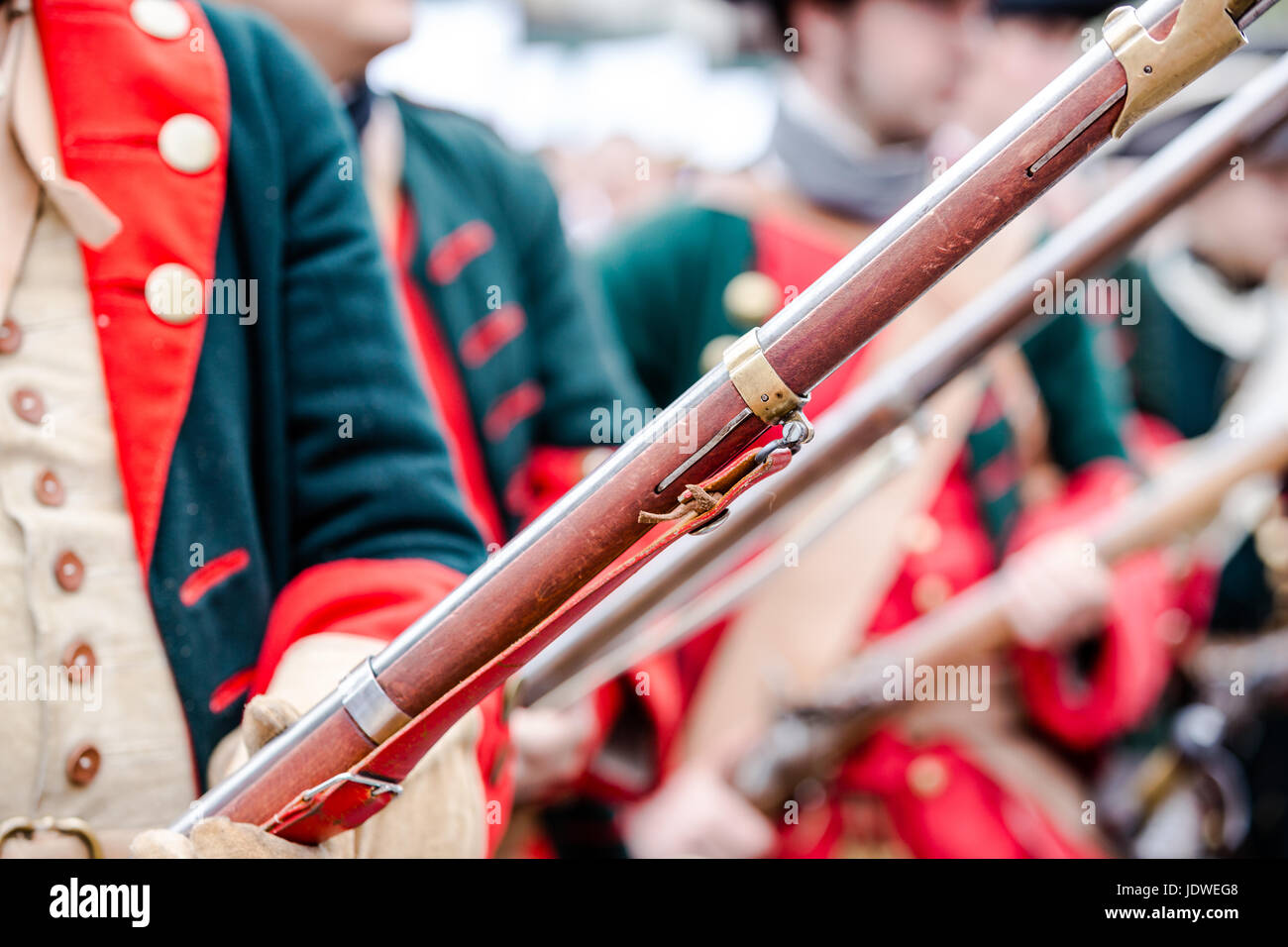 Building musketeers with guns. Focus on gun Stock Photo