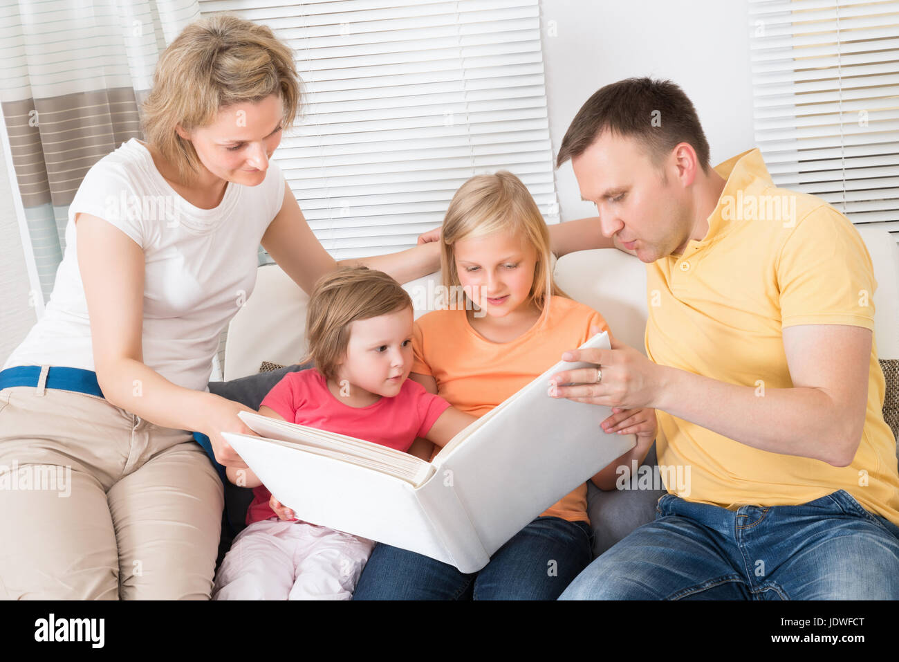 дети и родители вместе. семья смотрит книгу. семья смотрит книгу. современная семья. подросток смотрит фотоальбом.