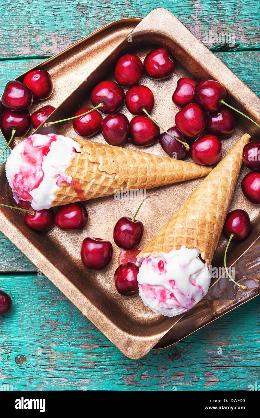 Summer vanilla ice cream in waffle cones and cherry berries Stock Photo