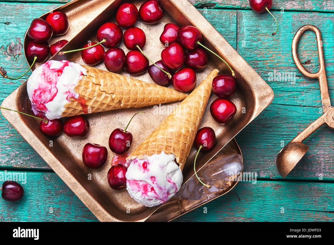 Summer vanilla ice cream in waffle cones and cherry berries Stock Photo