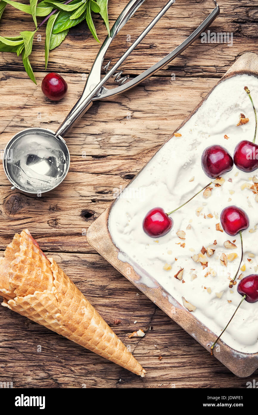 vanilla ice cream in waffle cones and cherry berries Stock Photo