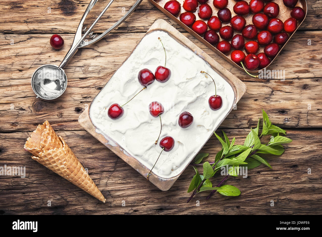 vanilla ice cream in waffle cones and cherry berries Stock Photo