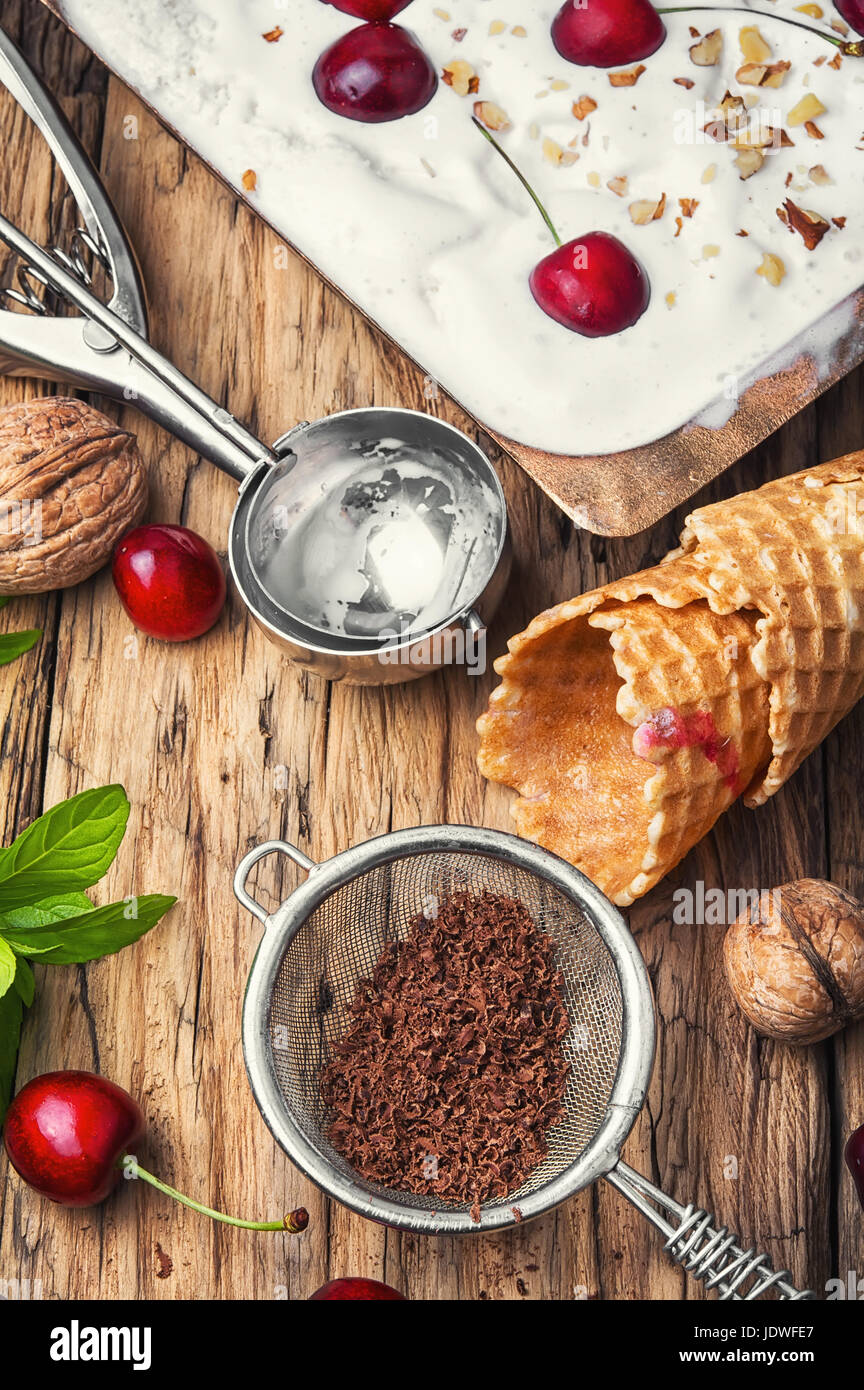 vanilla ice cream in waffle cones and cherry berries Stock Photo