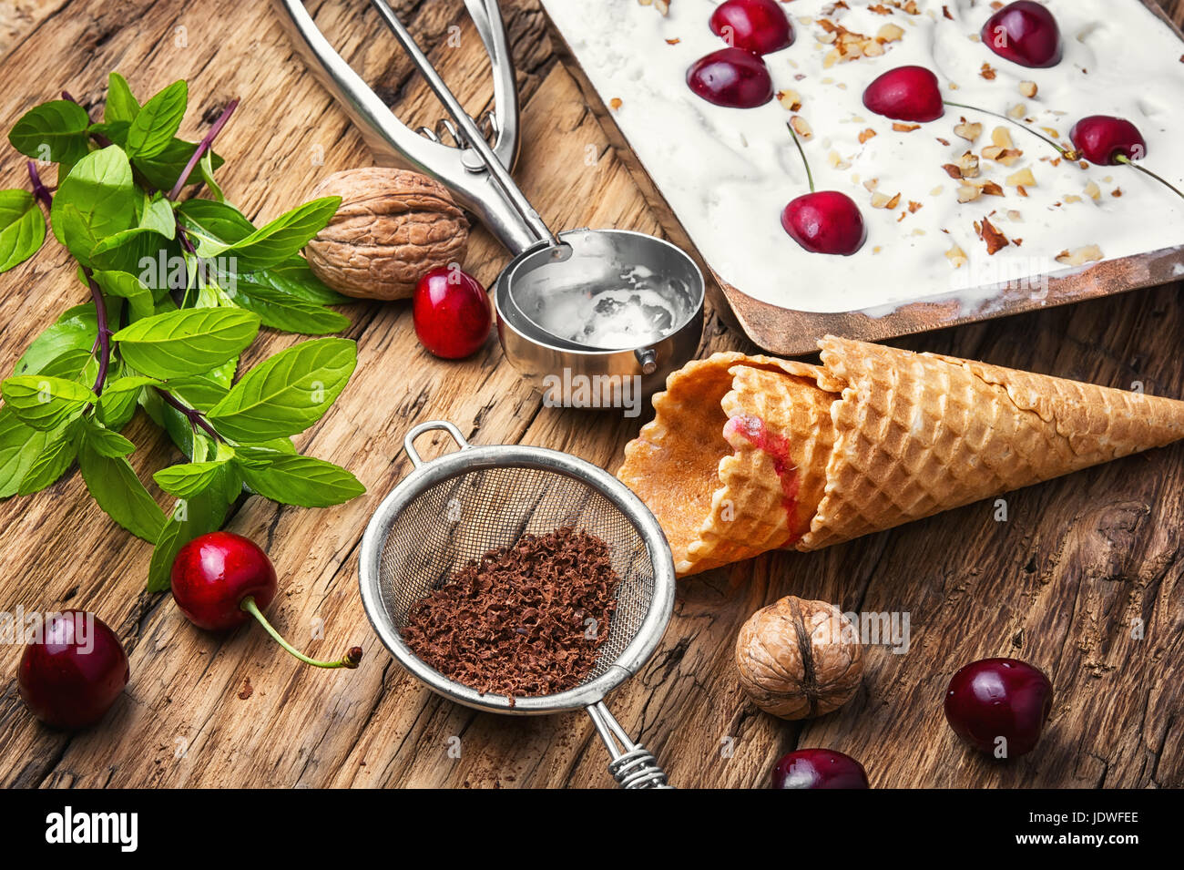 vanilla ice cream in waffle cones and cherry berries Stock Photo