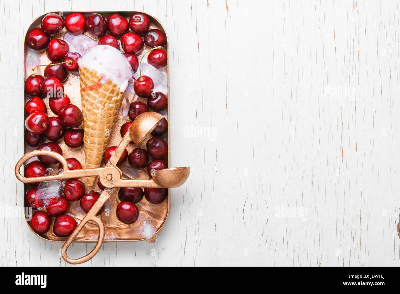 ice cream in waffle cones and cherry on white background Stock Photo