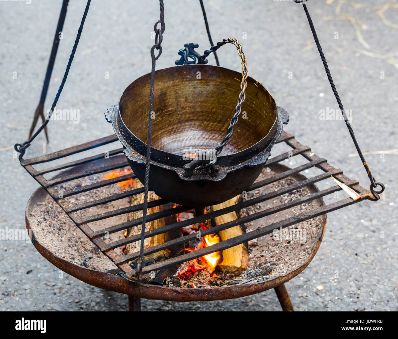 Cooking in old castiron on tripod Stock Photo Alamy