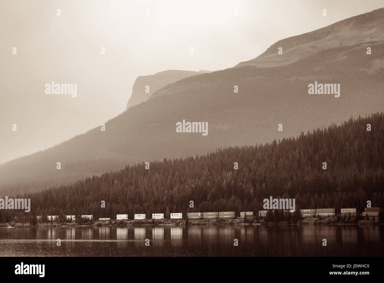BANFF, CANADA - AUGUST 27: Cargo train lake and mountain on August 27, 2015 in Banff National Park, Canada. Established in 1885, it is the oldest park Stock Photo