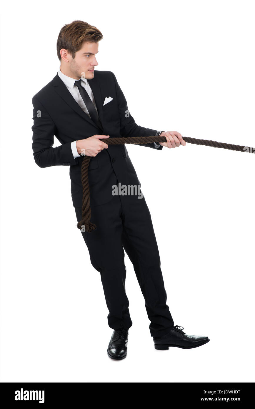 Pulling Against Rope Full length side view of businessman pulling rope against white ...