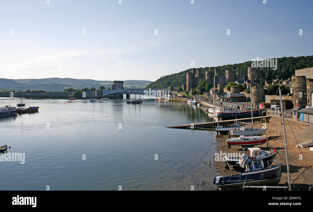 View of Conwy quay and the harbour showing the Castle and bridges across the river. Stock Photo