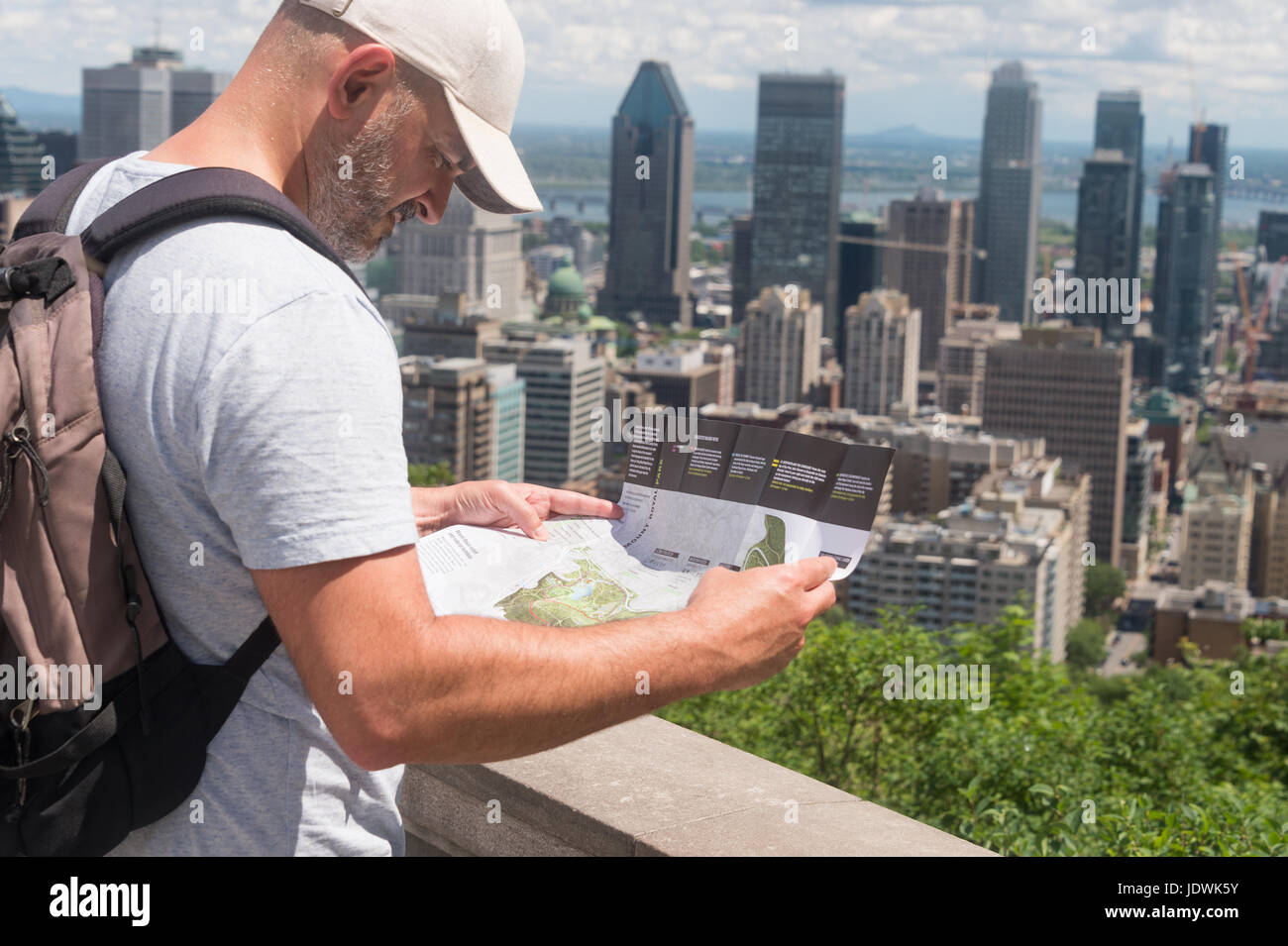 Tourist looking at Mount Royal Map at the Kondiaronk Belvedere on Mont Royal in Montreal, Quebec Province, Canada. Stock Photo