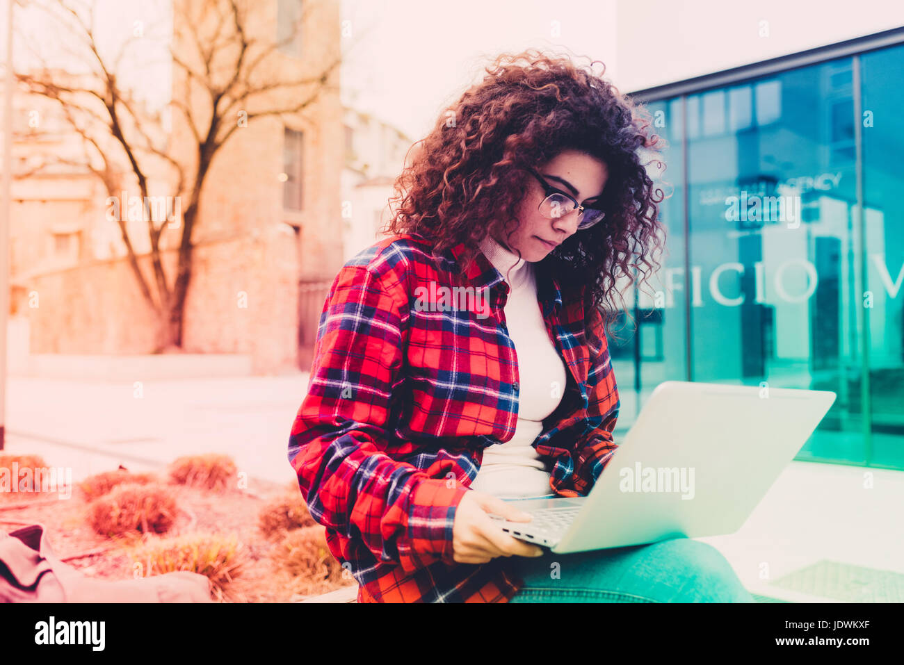 Young woman outdoor using computer outdoor in the city - small business ...