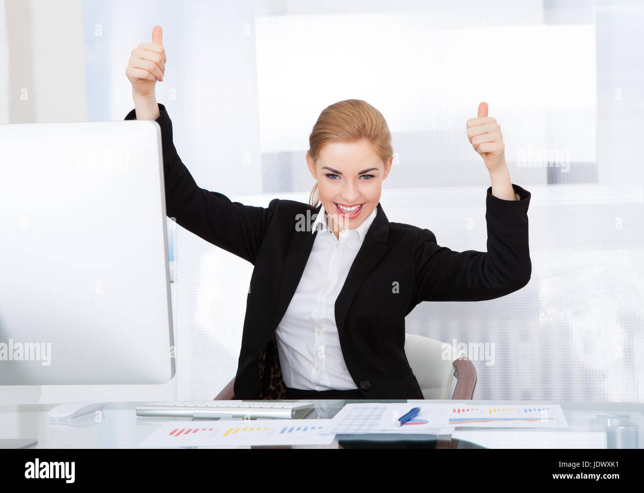 Happy Young Businesswoman In Office Showing Thumb Up Stock Photo - Alamy