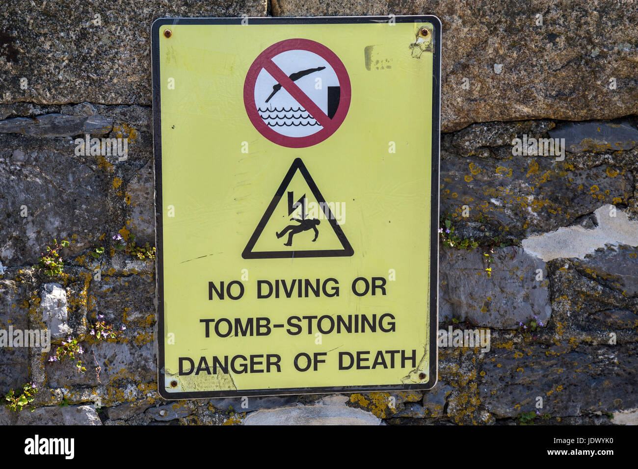 Sign saying No Diving Or Tomb Stoning, Danger of Death at Plymouth Harbour. Stock Photo