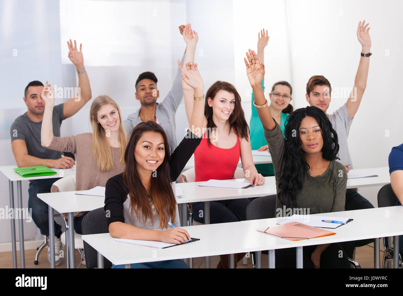 students raising hands